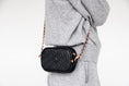 Load image into Gallery viewer, Woman wearing the black ettellon leather Ryan pouch as a crossbody bag with its removable chain strap.