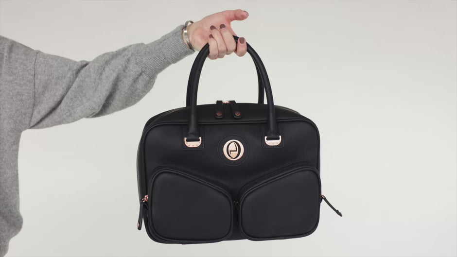 The black ettellon Luxe Ensemble carried by its handles, with its removable pouches shown.